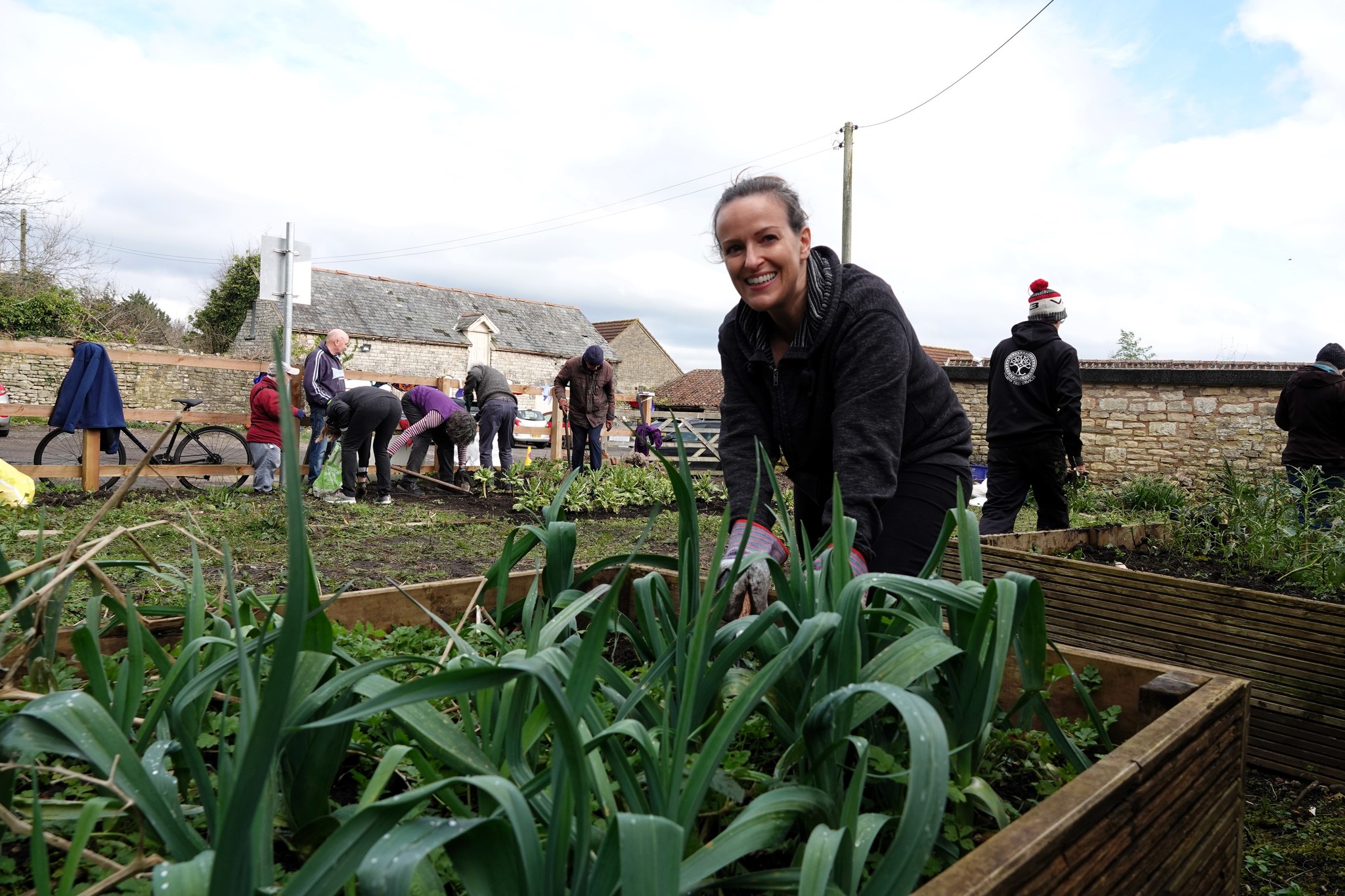 A vounteer works on the raised beds at a work day